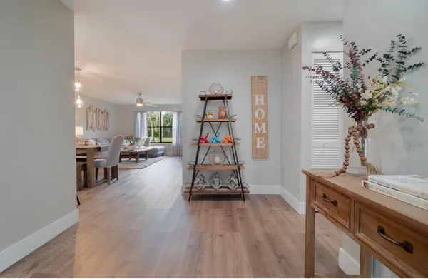 a living room with furniture and a chandelier
