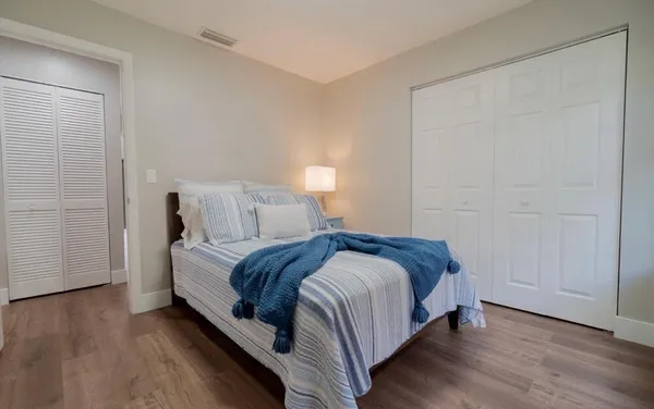 a bed sitting in a bedroom next to a bathroom