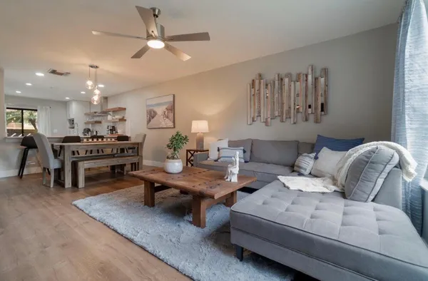 a living room with furniture and kitchen view