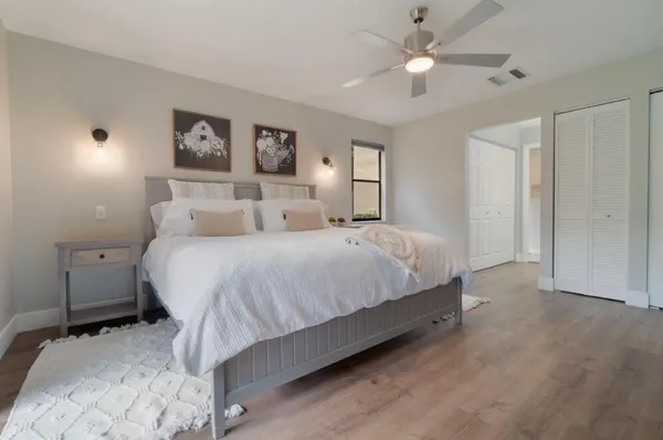 a bedroom with a bed and a chandelier