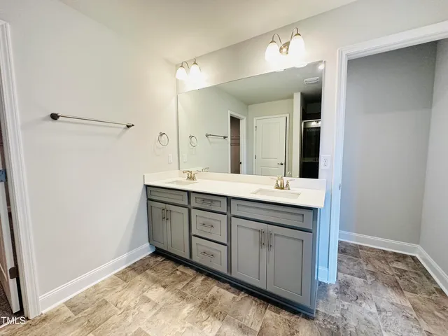 a bathroom with a sink vanity and mirror