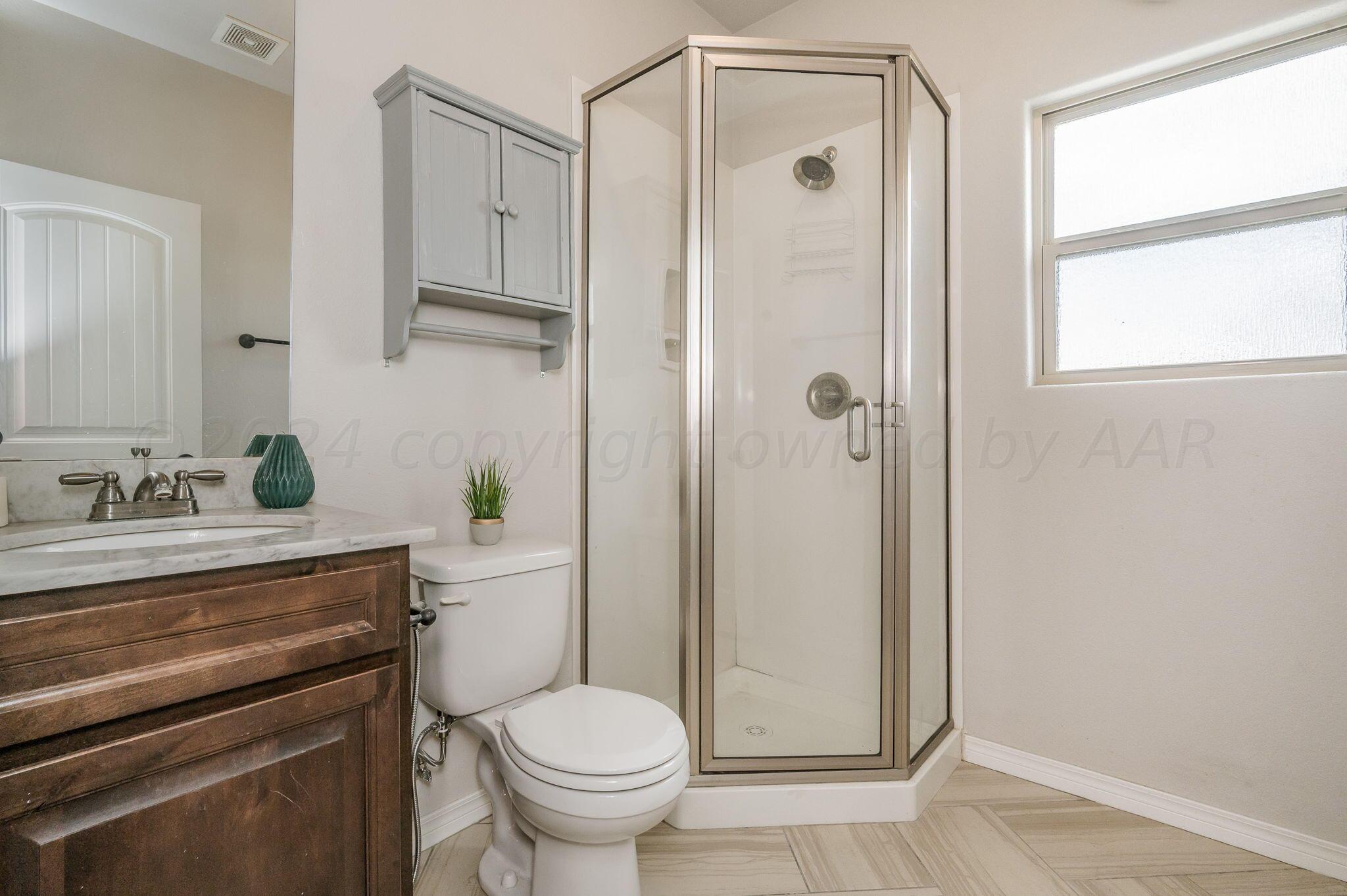1201 Cabernet Way Amarillo, TX 79124 - Photo 11 of 18 a bathroom with a shower a toilet and a sink