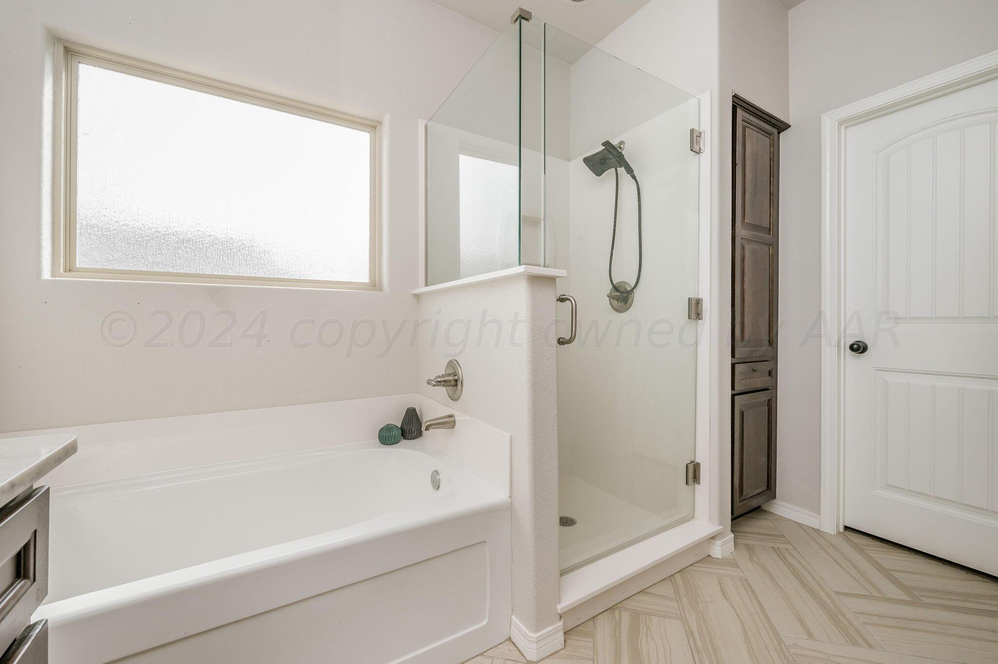 1201 Cabernet Way Amarillo, TX 79124 - Photo 16 of 18 a bathroom with a bath tub and a shower