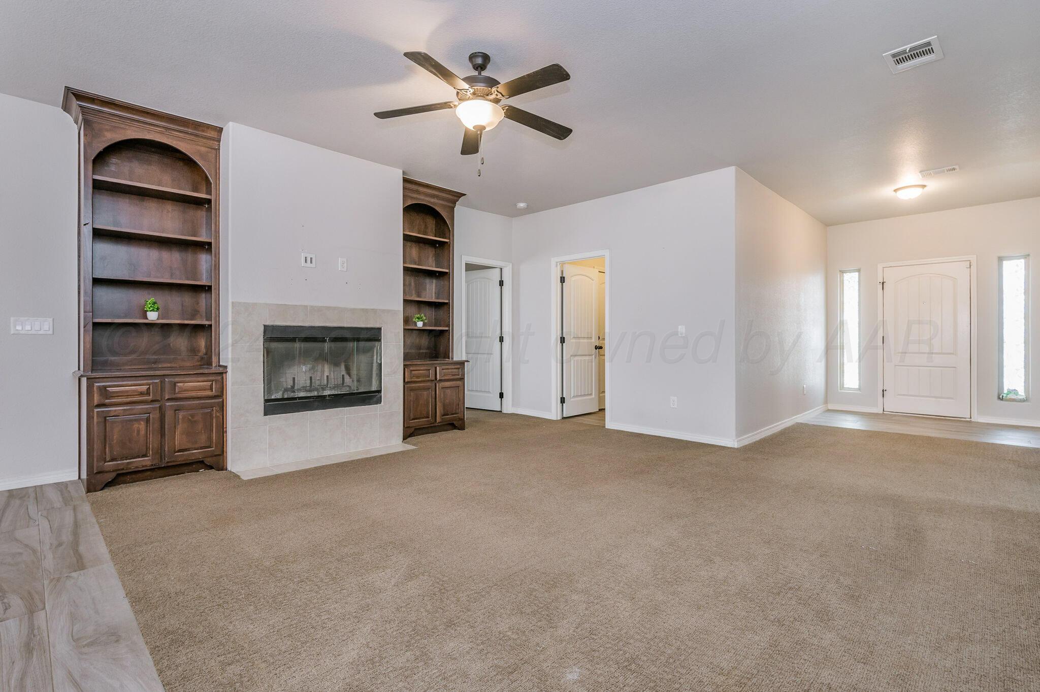 1201 Cabernet Way Amarillo, TX 79124 - Photo 3 of 18 a view of empty room with a fireplace and window