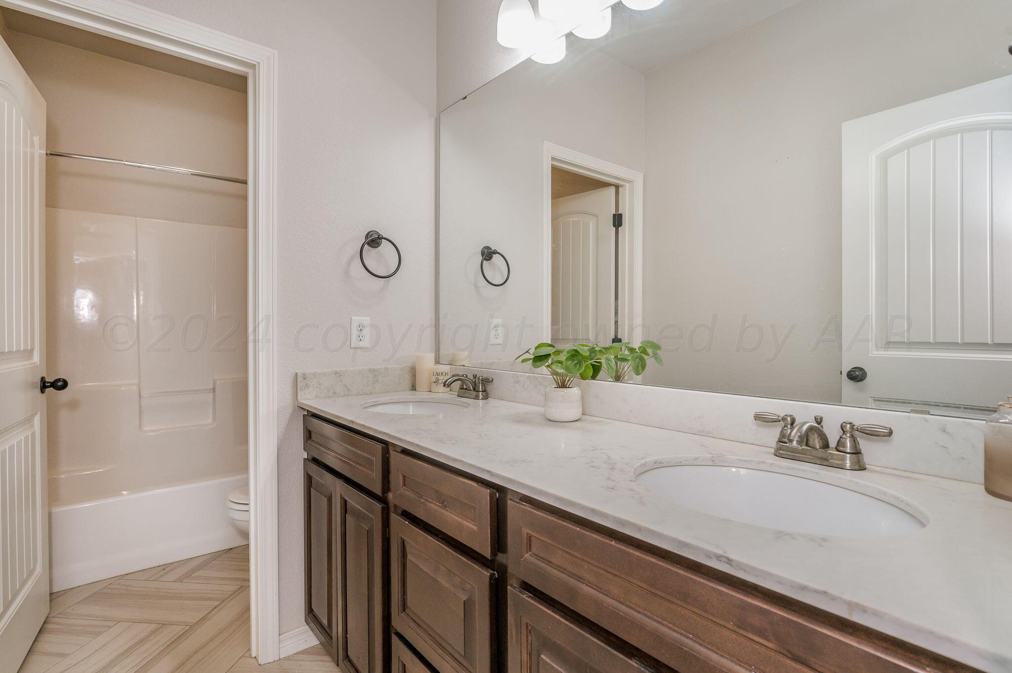 1201 Cabernet Way Amarillo, TX 79124 - Photo 8 of 18 a bathroom with a granite countertop sink and a mirror