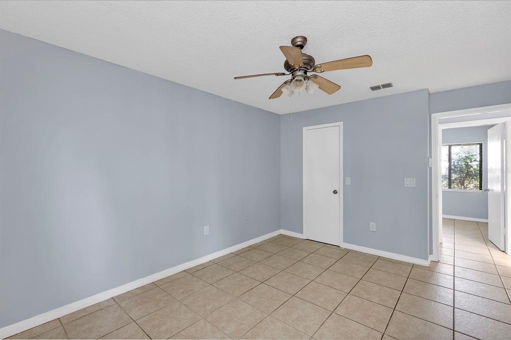 3701 Spring Land Drive Orlando, FL 32818 - Photo 14 of 21 a view of a room with a ceiling fan and carpet