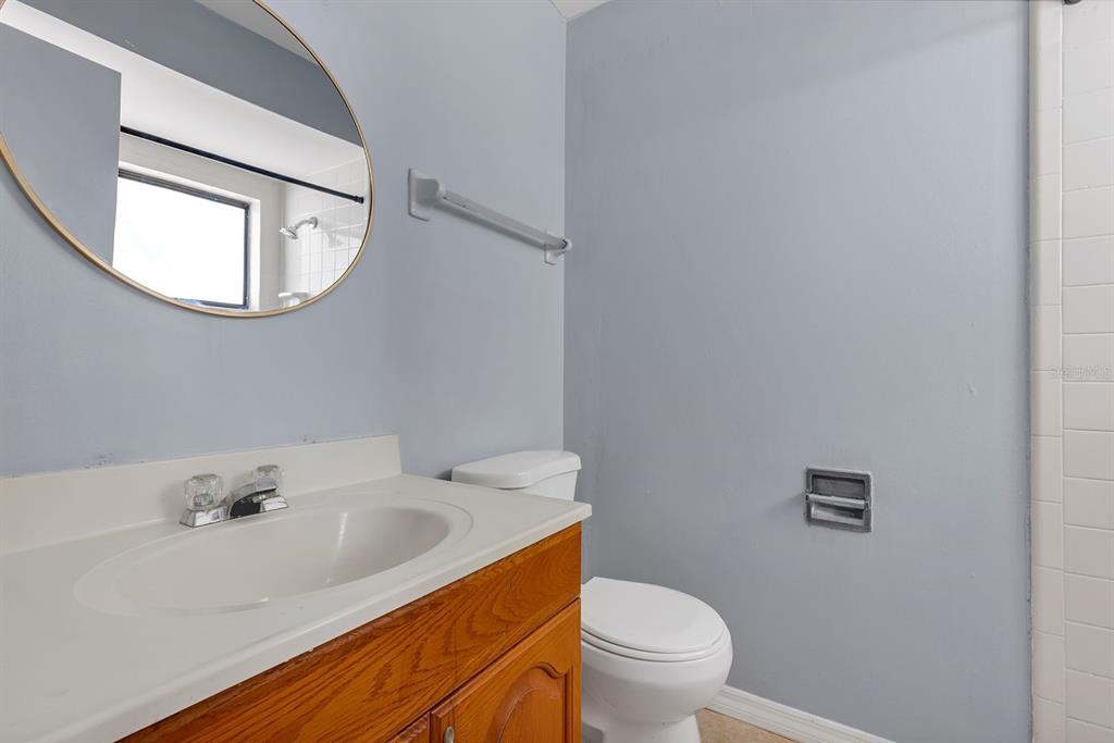 3701 Spring Land Drive Orlando, FL 32818 - Photo 16 of 21 a bathroom with a sink vanity mirror and toilet