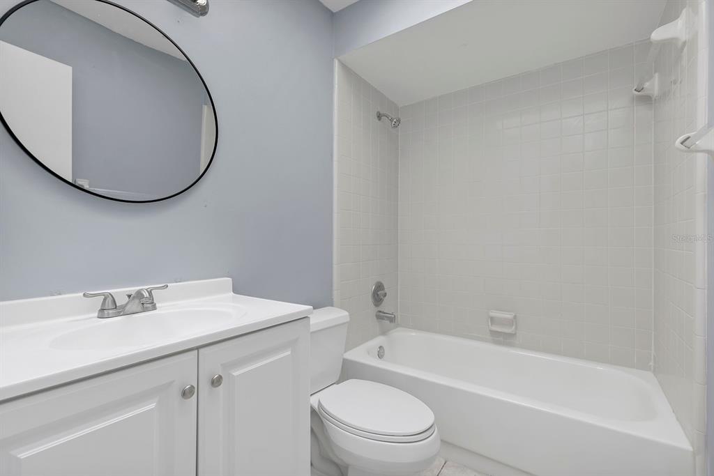 3701 Spring Land Drive Orlando, FL 32818 - Photo 19 of 21 a bathroom with a sink a toilet and a mirror