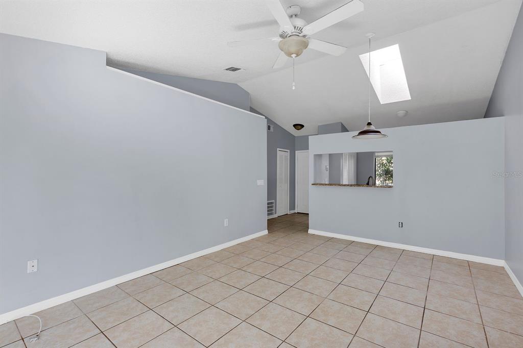 3701 Spring Land Drive Orlando, FL 32818 - Photo 2 of 21 an empty room with windows and fan