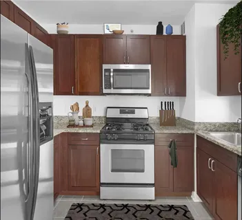 a kitchen with stainless steel appliances a stove a sink and a refrigerator
