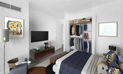 a bedroom with a bed and a flat tv screen