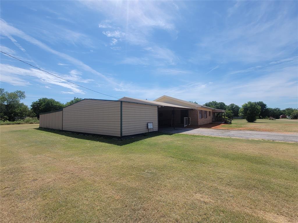 215 Cedar Court Graham, TX 76450 - Photo 10 of 39 Side of the Storage Room that is attached to the Carport.