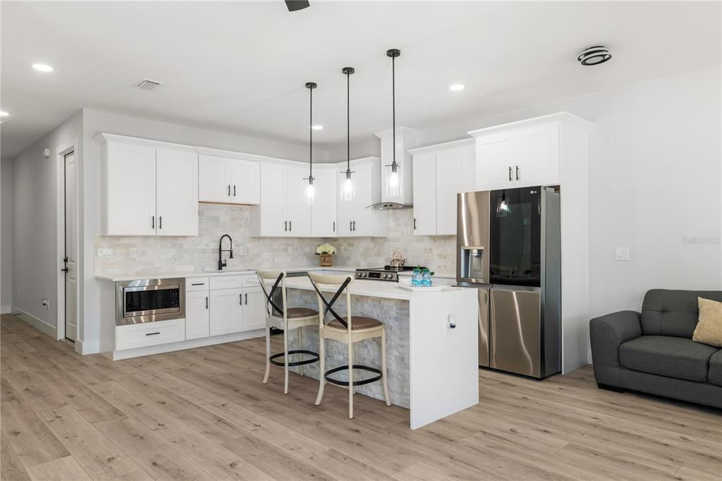 2608 West St Joseph Street, Unit 2 Tampa, FL 33607 - Photo 16 of 29 a kitchen with white cabinets and stainless steel appliances