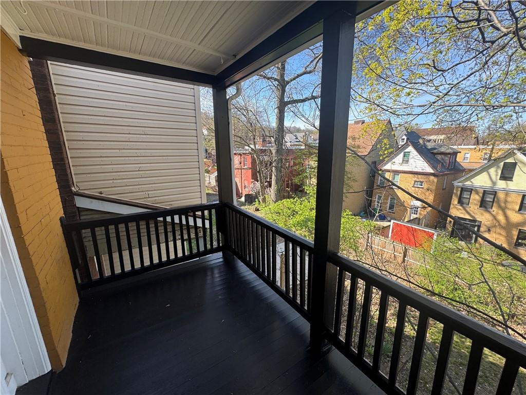 5423 Wellesley Avenue Pittsburgh, PA 15206 - Photo 19 of 27 a view of a porch with wooden floor