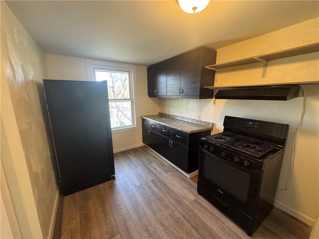 5423 Wellesley Avenue Pittsburgh, PA 15206 - Photo 21 of 27 a kitchen with a stove and a refrigerator