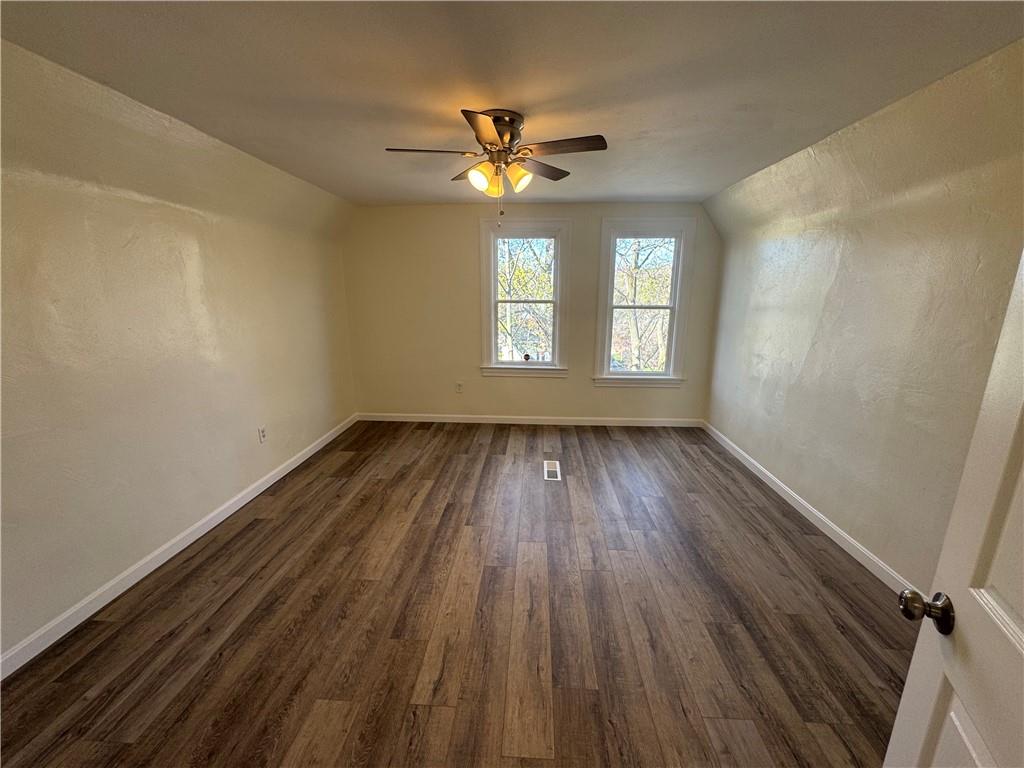 5423 Wellesley Avenue Pittsburgh, PA 15206 - Photo 23 of 27 a view of empty room with wooden floor and fan