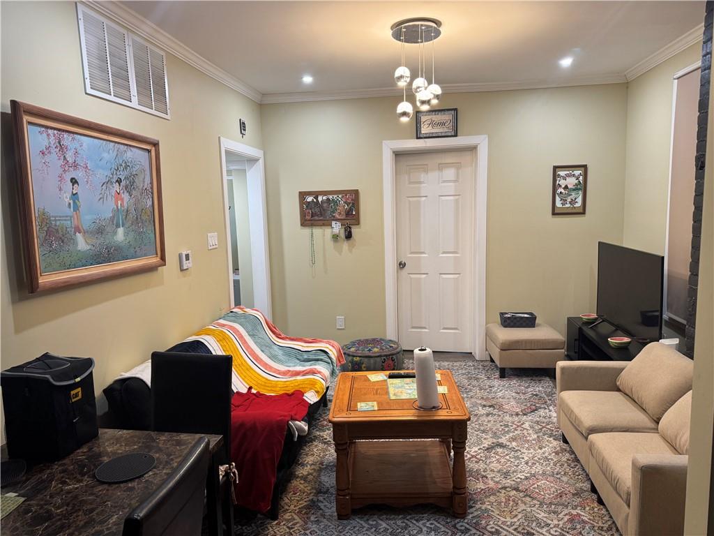 5423 Wellesley Avenue Pittsburgh, PA 15206 - Photo 7 of 27 a living room with furniture a couch and a chandelier