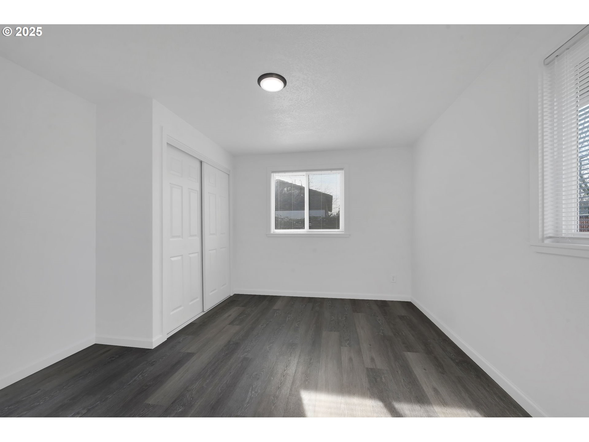 1899 Scott Road Springfield, OR 97477 - Photo 25 of 36 a view of an empty room with wooden floor and a window