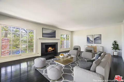 a living room with furniture a window and a fireplace