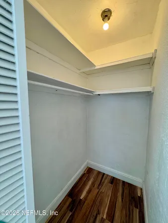 a view of a room with wooden floor