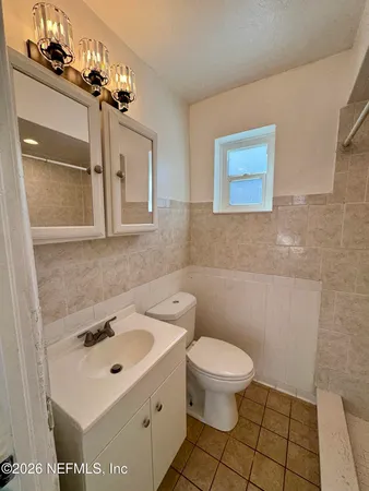 a bathroom with a sink toilet and mirror