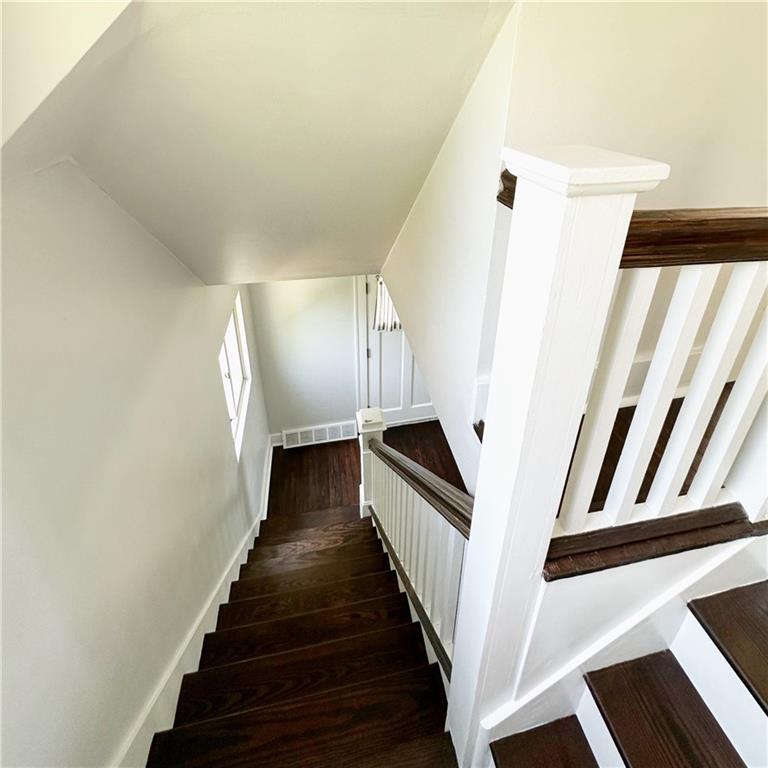136 Morgan Street Lower Burrell, PA 15068 - Photo 15 of 32 a view of staircase with lots of frames on wall and wooden floor