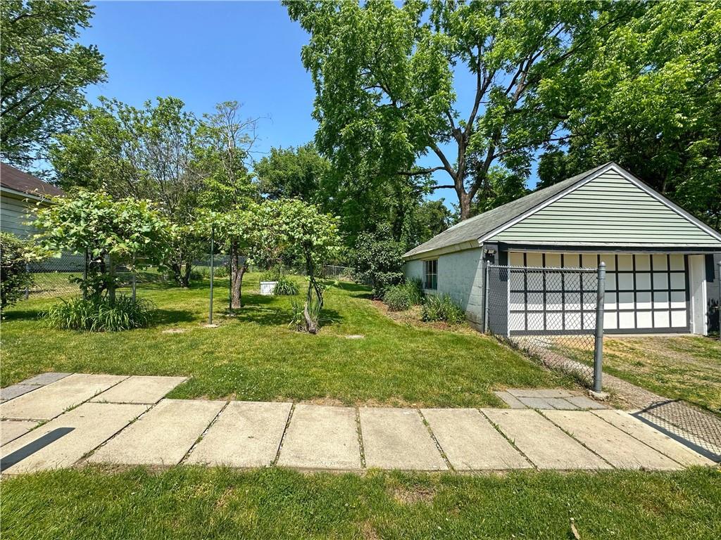 136 Morgan Street Lower Burrell, PA 15068 - Photo 20 of 32 a front view of a house with a garden