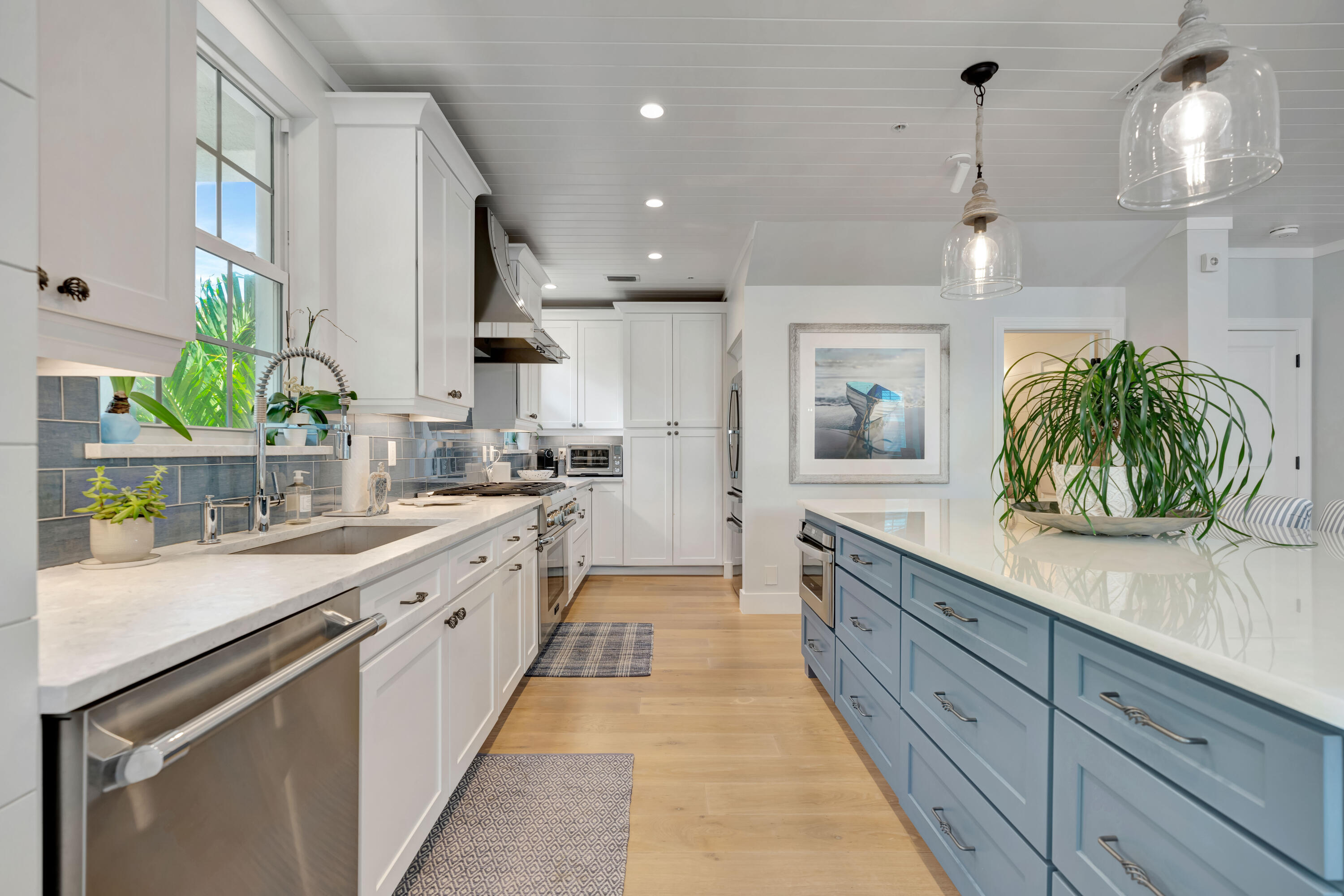 270 Mercury Road, Unit D Juno Beach, FL 33408 - Photo 16 of 107 a large kitchen with stainless steel appliances kitchen island granite countertop a sink a counter space and a view of living room