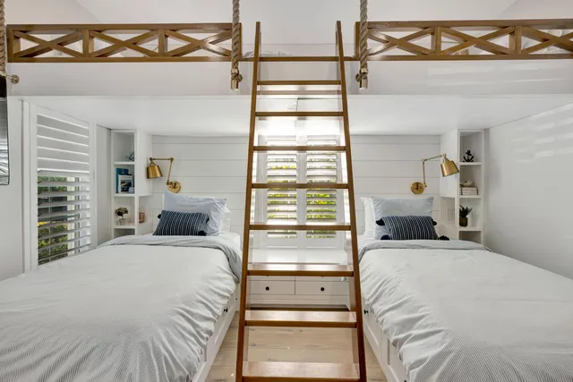 a spacious bedroom with a bed and large window