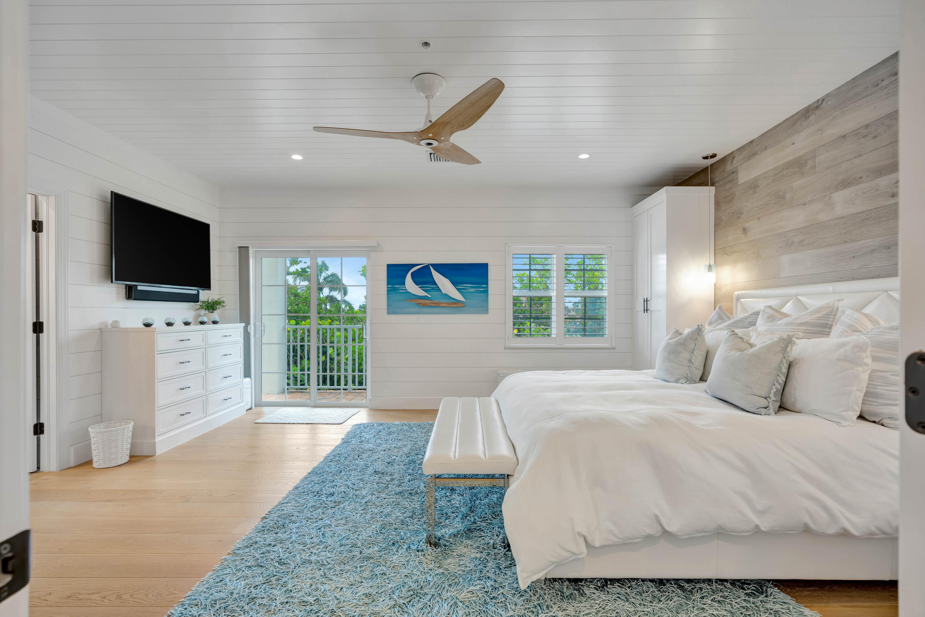 270 Mercury Road, Unit D Juno Beach, FL 33408 - Photo 46 of 107 a spacious bedroom with a bed and a flat screen tv