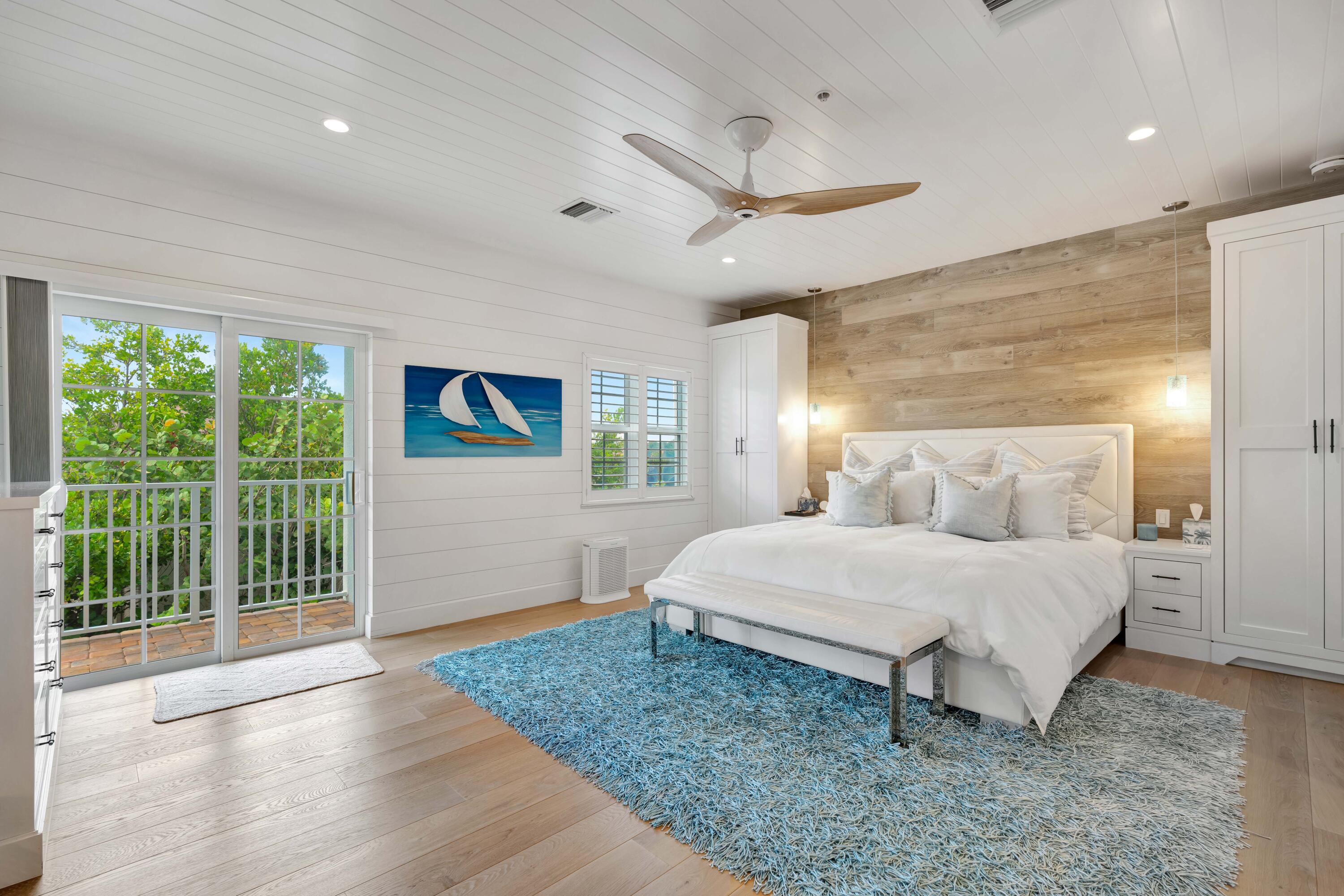 270 Mercury Road, Unit D Juno Beach, FL 33408 - Photo 47 of 107 a spacious bedroom with a bed and large window