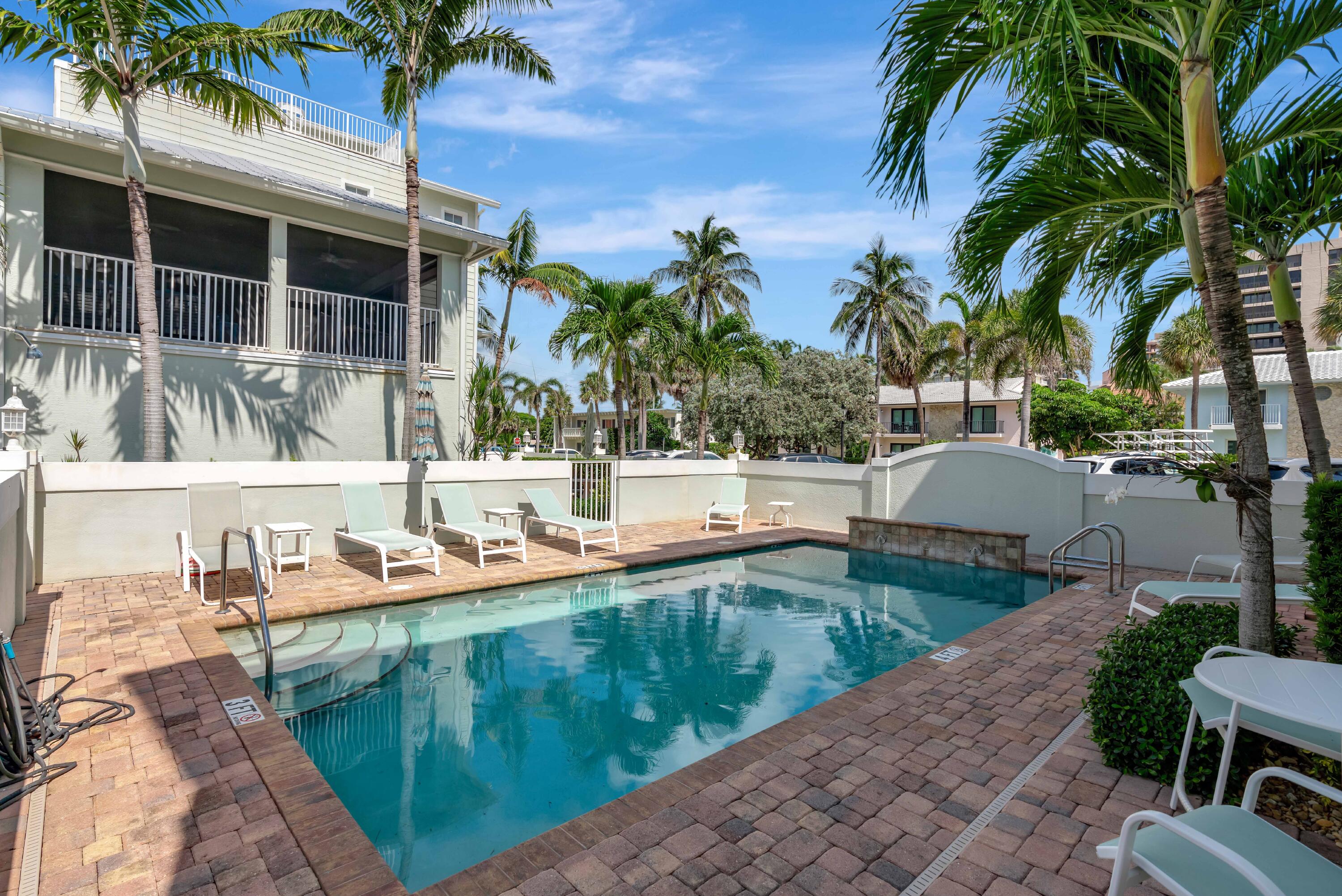 270 Mercury Road, Unit D Juno Beach, FL 33408 - Photo 81 of 107 a view of a house with swimming pool and a sitting area
