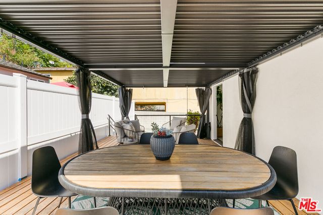 a view of a dining room with furniture and a large window