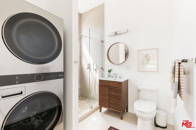 a bathroom with a toilet a sink and a mirror