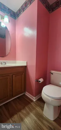 a bathroom with a sink a toilet and mirror