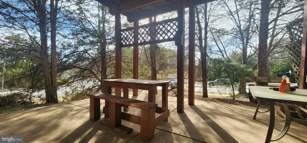 a view of deck with wooden floor and outdoor seating