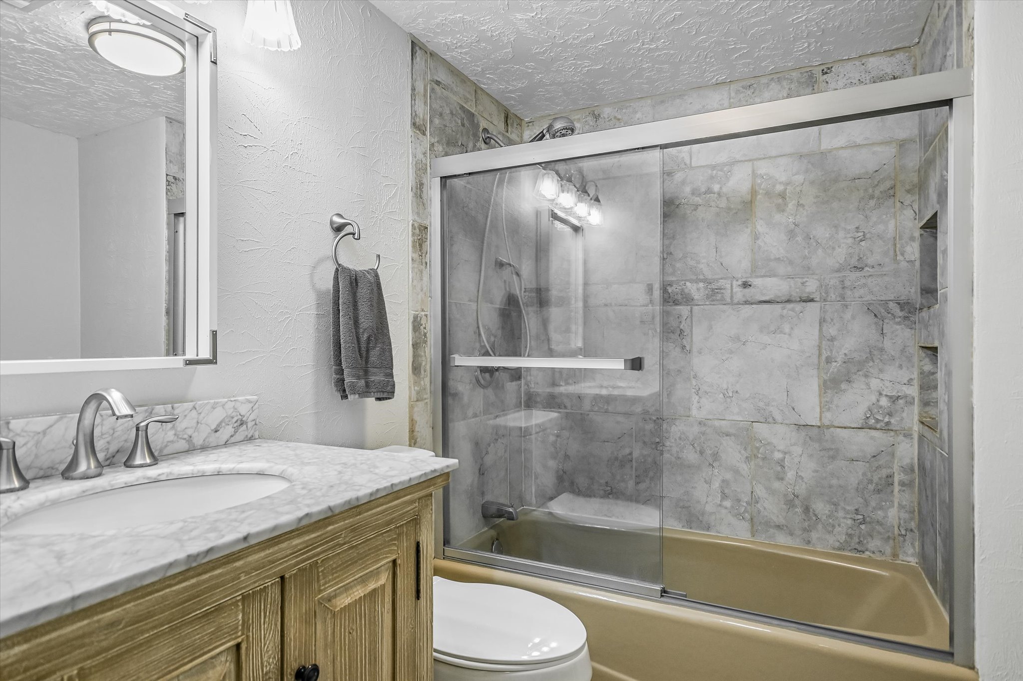 175 Fischer Trail Wimberley, TX 78676 - Photo 11 of 31 a bathroom with a granite countertop sink toilet and shower