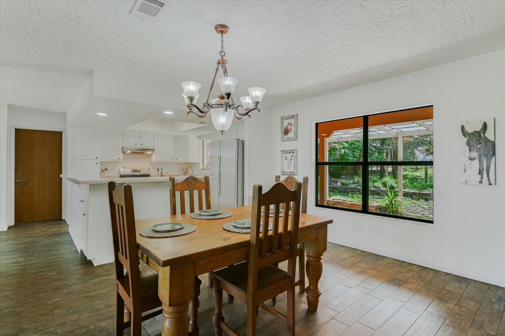 175 Fischer Trail Wimberley, TX 78676 - Photo 4 of 31 a view of a dining room with furniture window and wooden floor