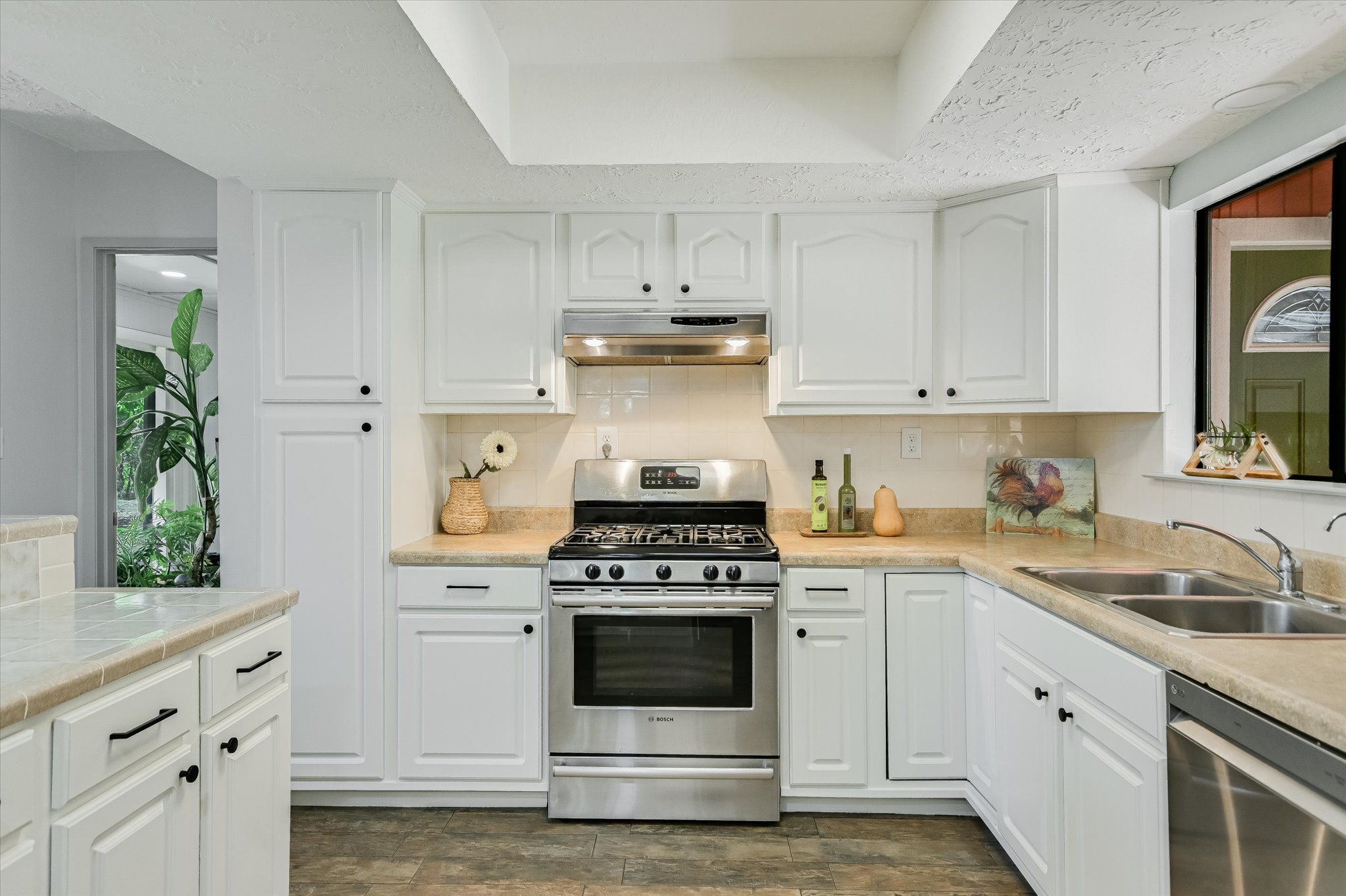 175 Fischer Trail Wimberley, TX 78676 - Photo 5 of 31 a kitchen with granite countertop white cabinets and stainless steel appliances