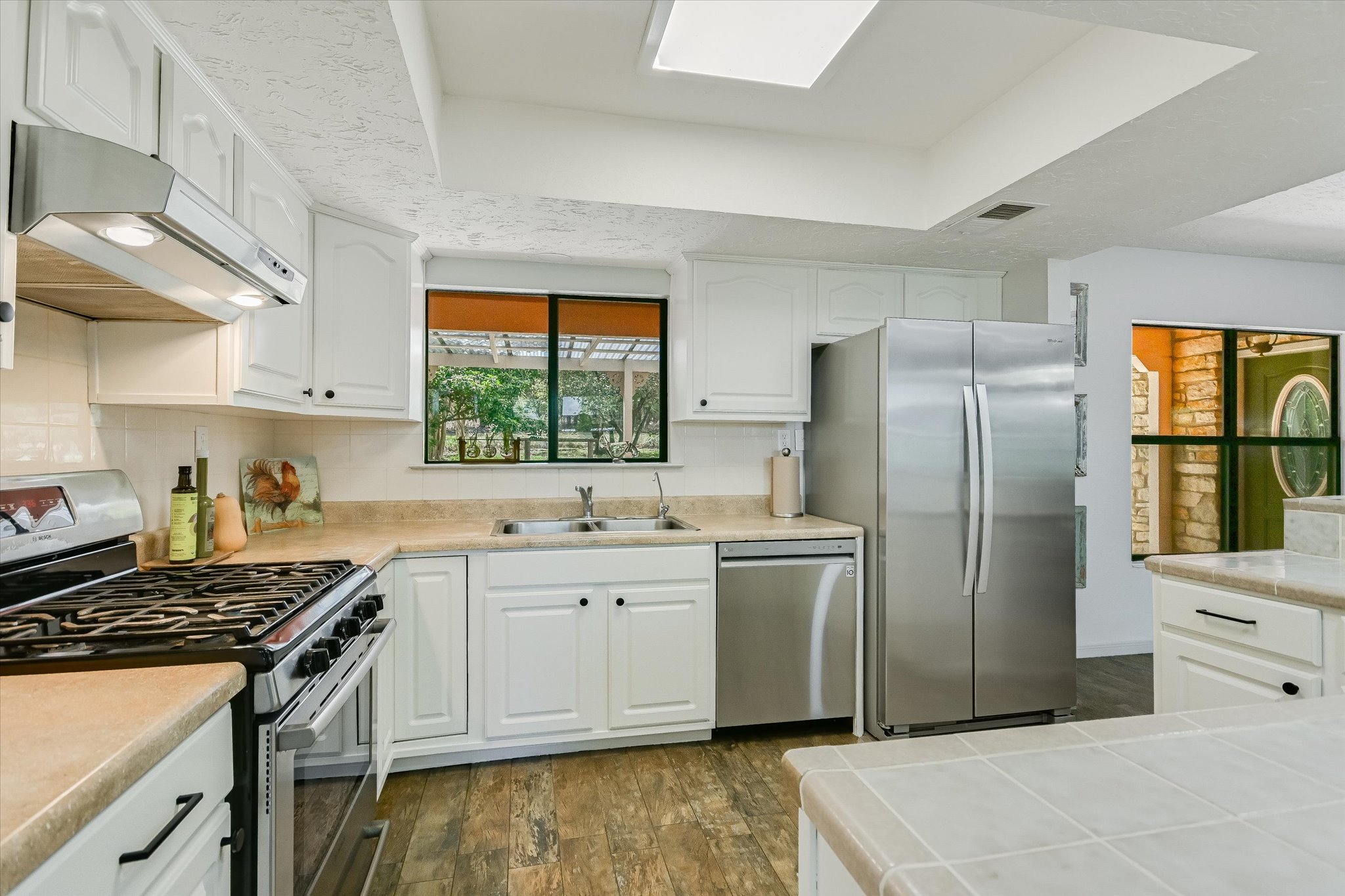 175 Fischer Trail Wimberley, TX 78676 - Photo 6 of 31 a kitchen with stainless steel appliances granite countertop a sink stove and refrigerator