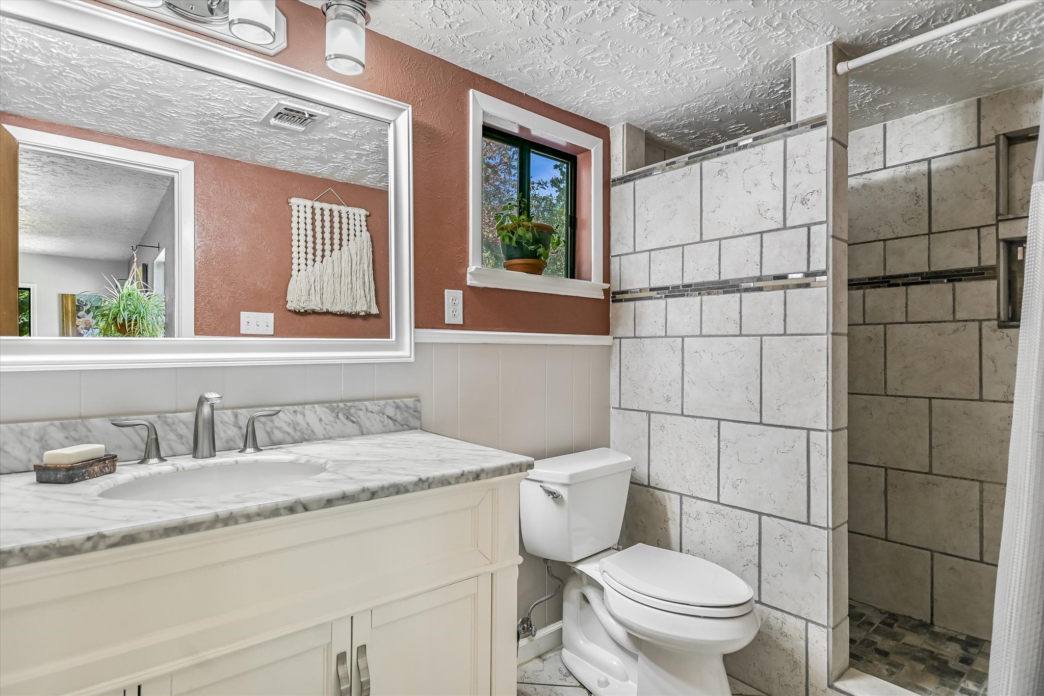 175 Fischer Trail Wimberley, TX 78676 - Photo 8 of 31 a bathroom with a granite countertop toilet sink and mirror