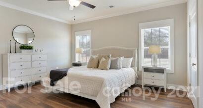 3410 Sincerity Road, Unit 1 Monroe, NC 28110 - Photo 22 of 32 a bedroom with a bed and a chandelier