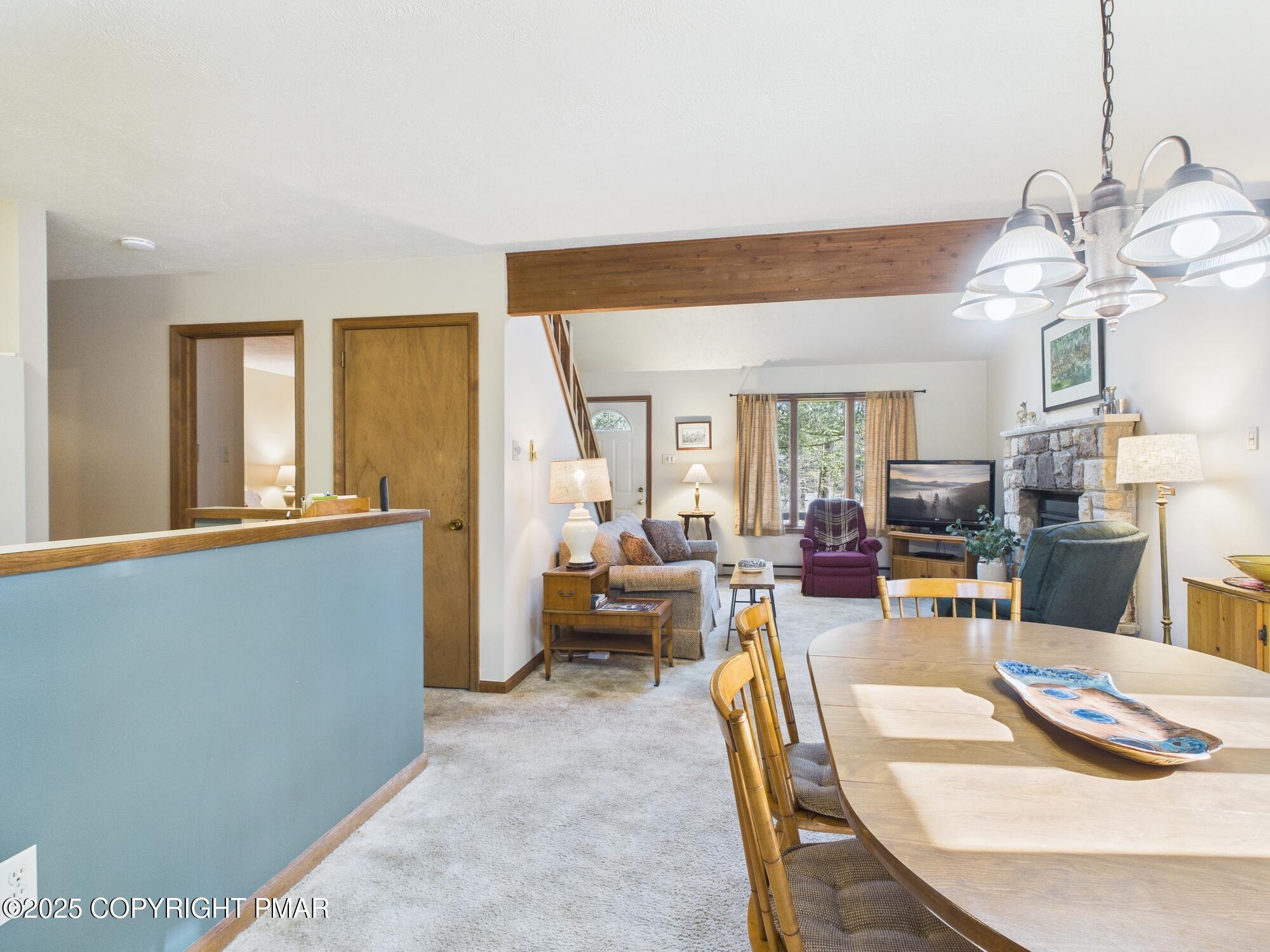 266 King Arthur Road Pocono Lake, PA 18347 - Photo 11 of 26 a living room with furniture and a chandelier