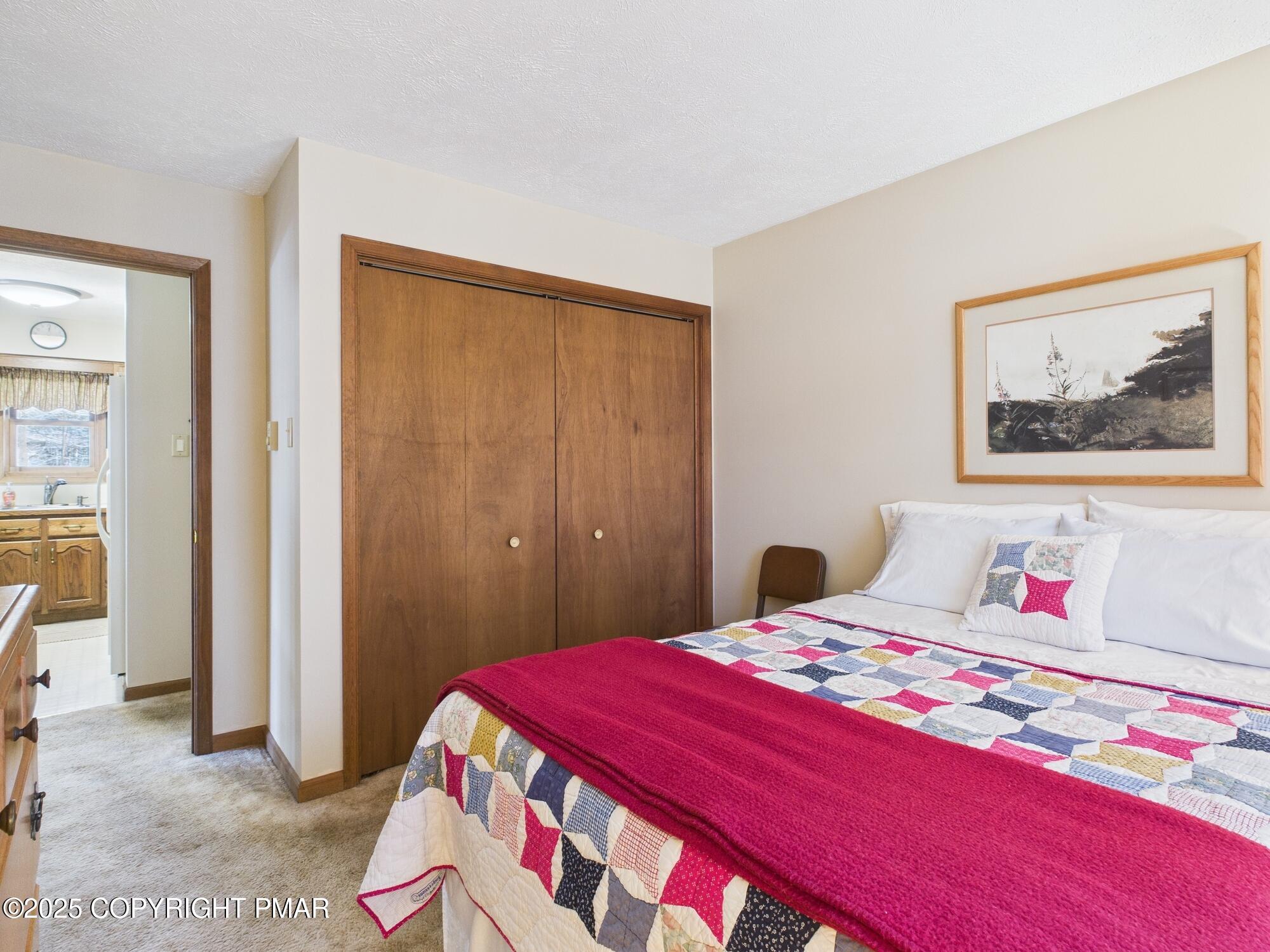 266 King Arthur Road Pocono Lake, PA 18347 - Photo 13 of 26 a bedroom with a bed and a painting on the wall