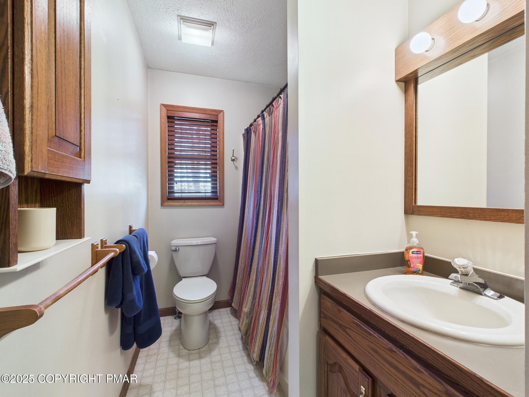 266 King Arthur Road Pocono Lake, PA 18347 - Photo 14 of 26 a bathroom with a sink a toilet and a mirror