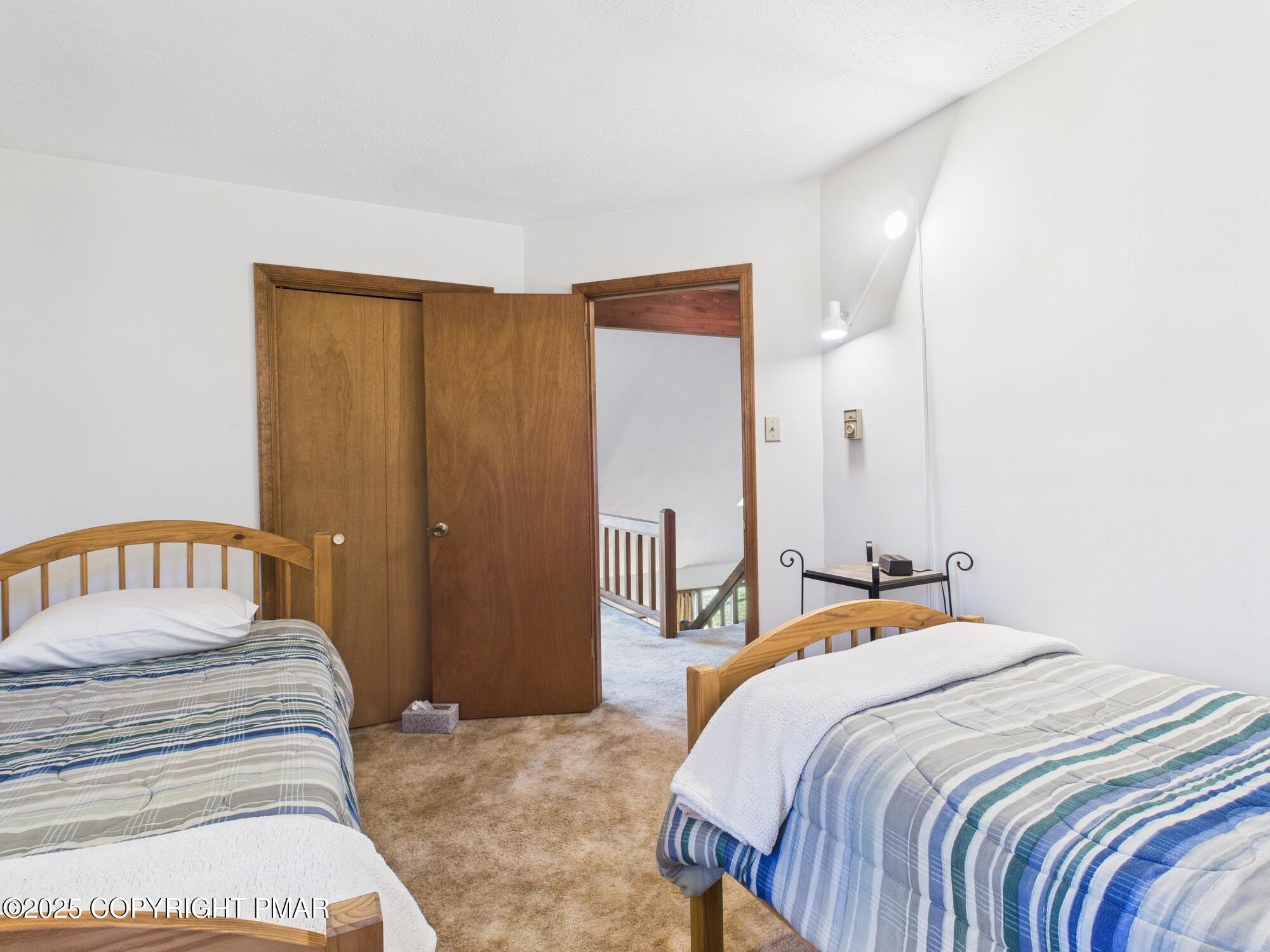 266 King Arthur Road Pocono Lake, PA 18347 - Photo 20 of 26 a bedroom with a large bed and a chandelier