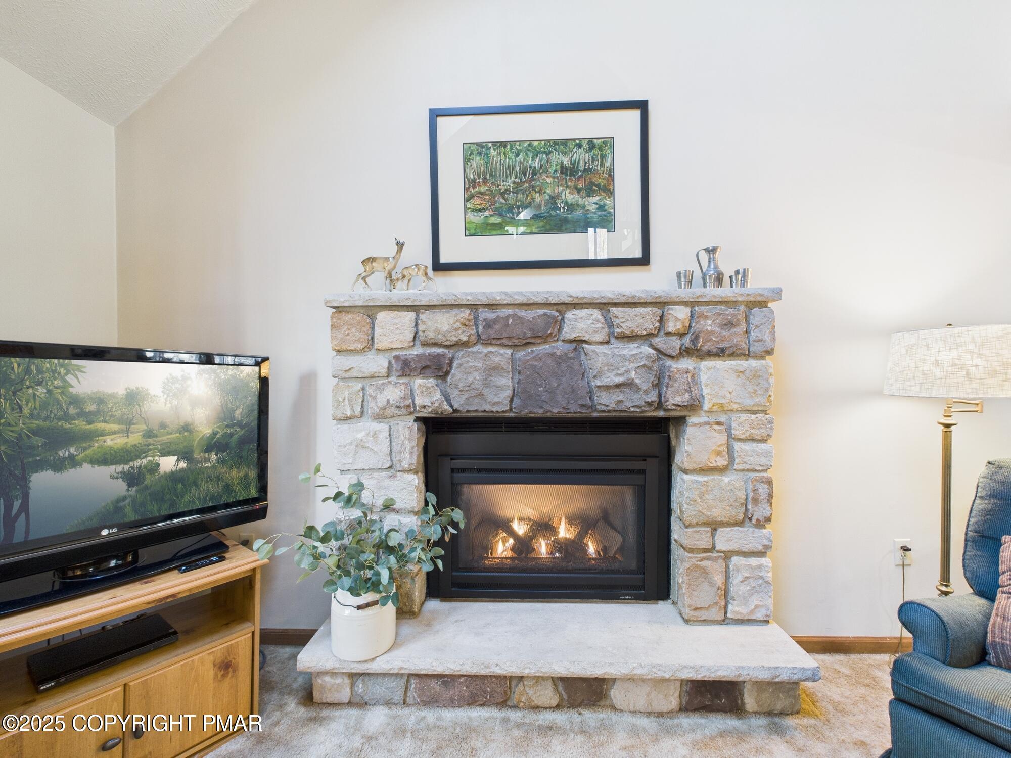 266 King Arthur Road Pocono Lake, PA 18347 - Photo 5 of 26 a living room with furniture a flat screen tv and a fireplace