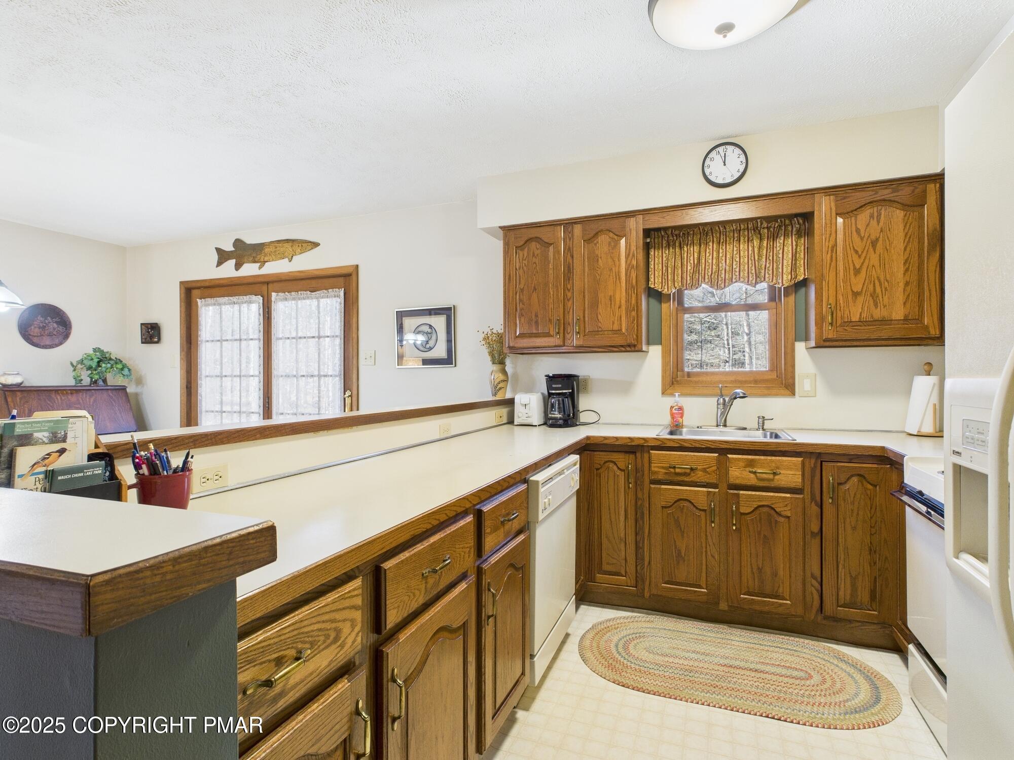 266 King Arthur Road Pocono Lake, PA 18347 - Photo 6 of 26 a kitchen with a sink stove and cabinets