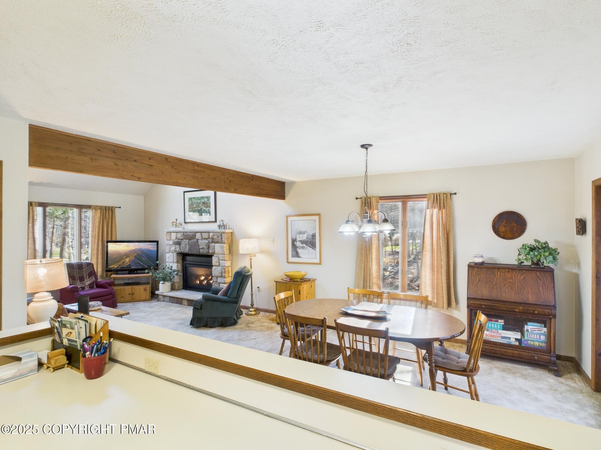 266 King Arthur Road Pocono Lake, PA 18347 - Photo 10 of 26 a living room with furniture and a chandelier