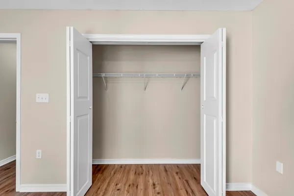 a view of a room with wooden floor